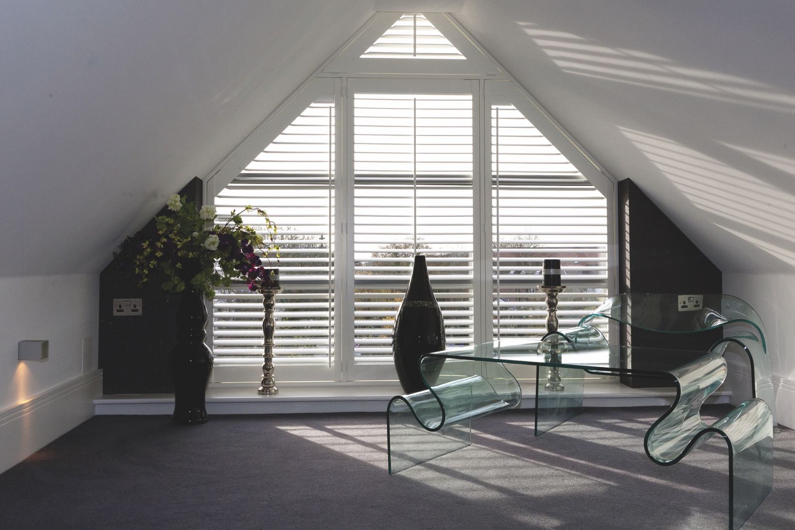 White plantation shutters in modern loft space